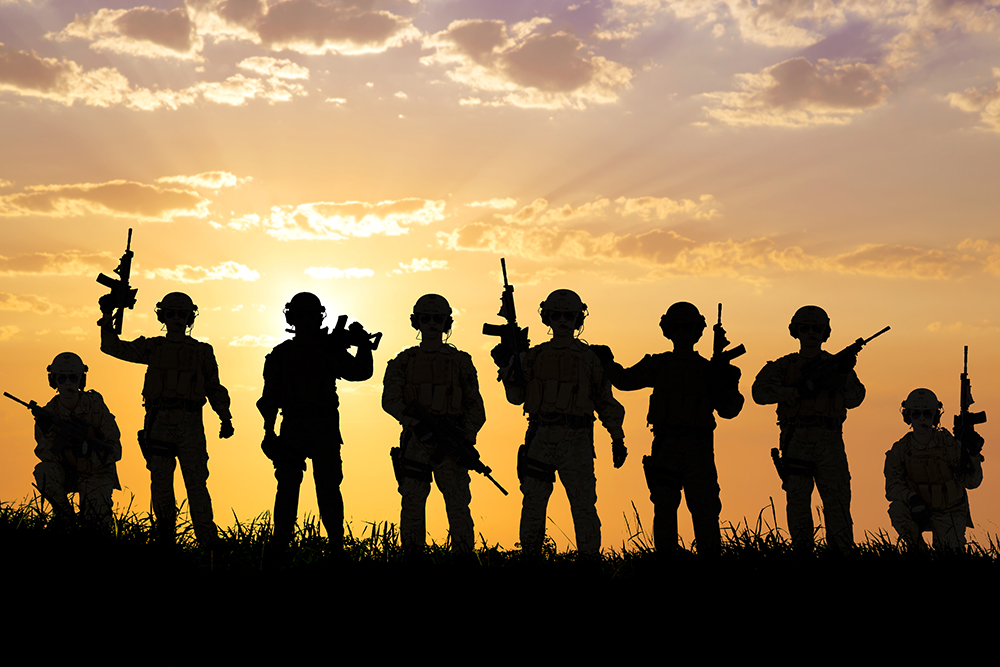 Silhouette of soldiers with sunrise background